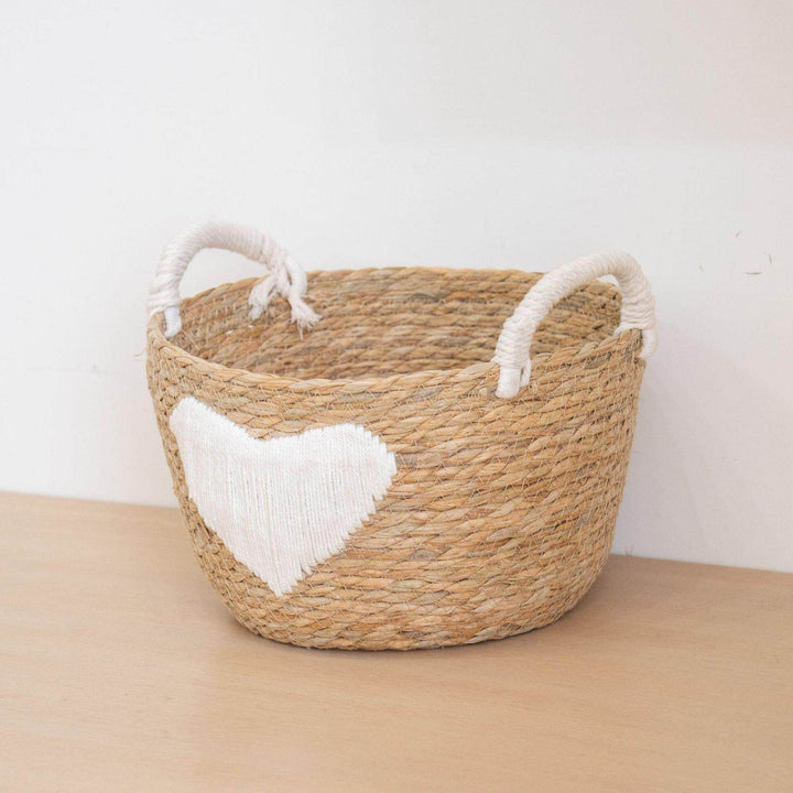 Handwoven storage basket with heart design