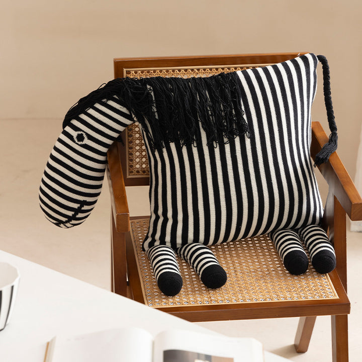 Striped decorative knitted cushion in animal shape with fringes and four-legged look