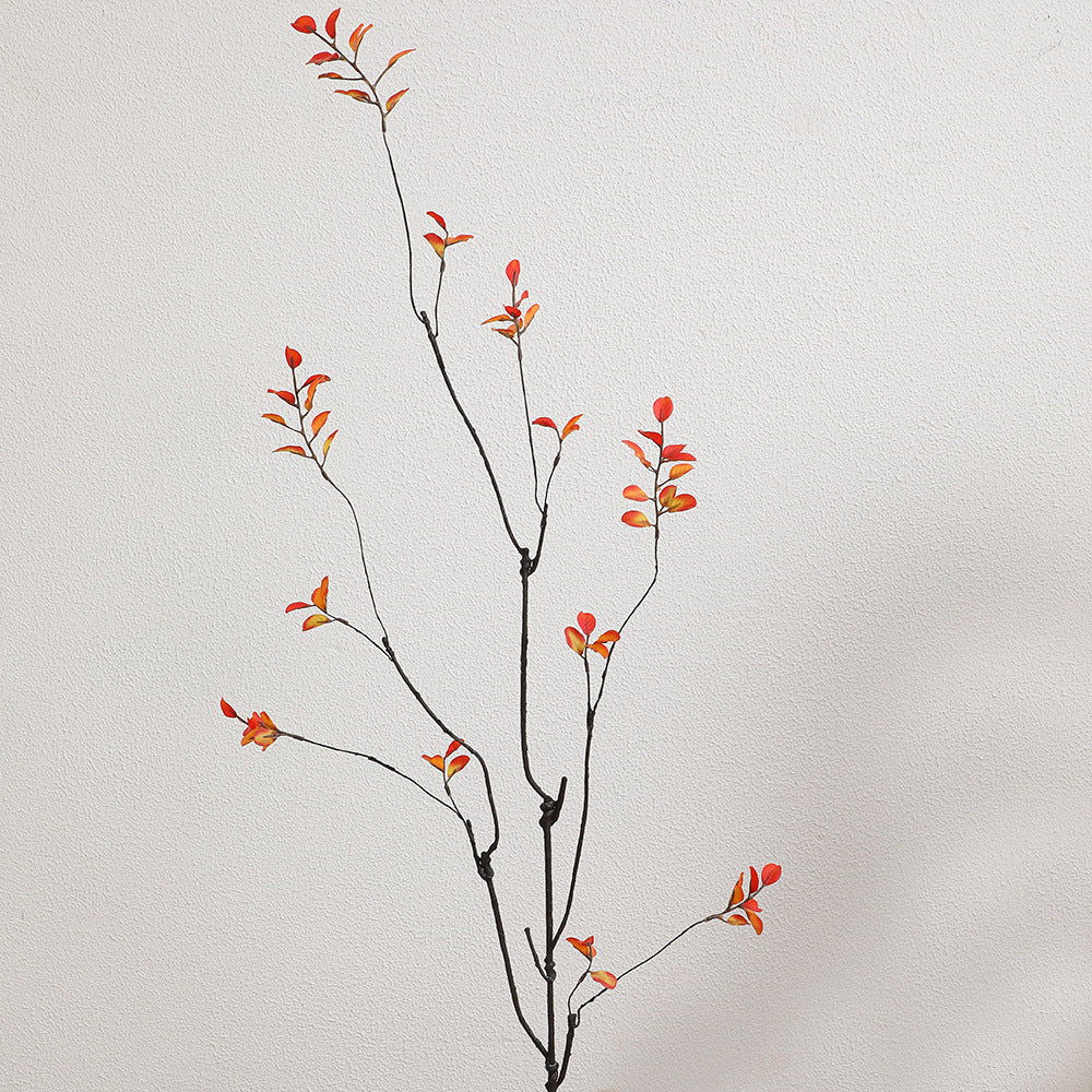 Artificial flower branch with vibrant orange flowers