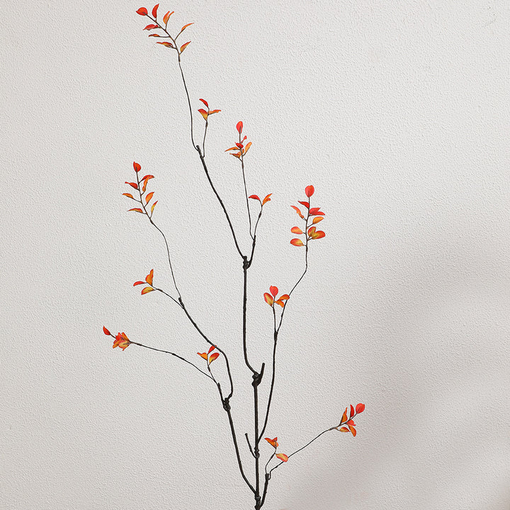 Artificial flower branch with vibrant orange flowers