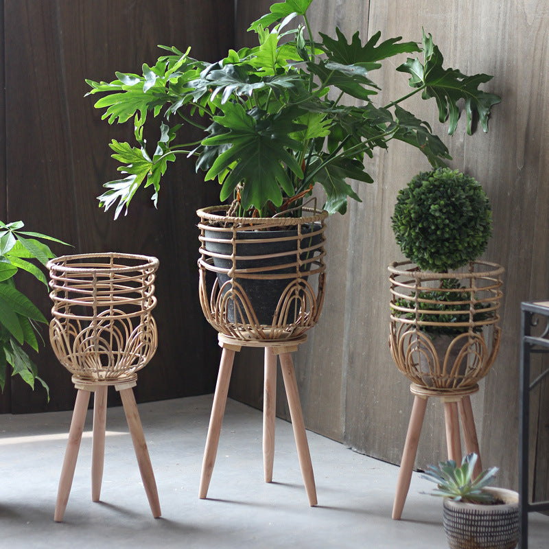 Stylish plant stand made of rattan and wood
