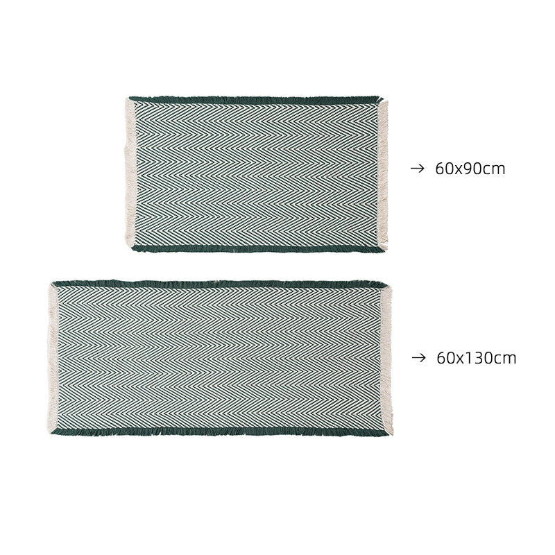 Handwoven cotton bath mat with herringbone pattern and fringes