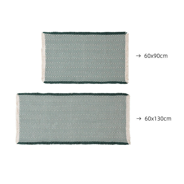 Handwoven cotton bath mat with herringbone pattern and fringes