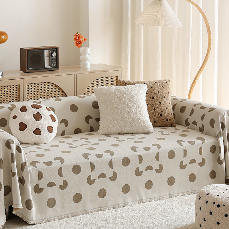 three-seater universal protective cover made of jacquard fabric with geometric pattern