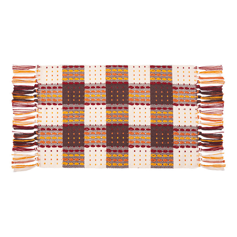 Woven colorful table runner with fringes and checkered structure