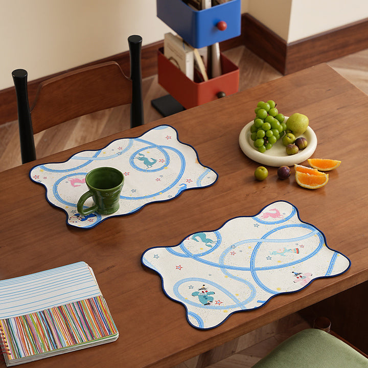 Playful shaped table runner with colorful animal illustrations and decorative edge