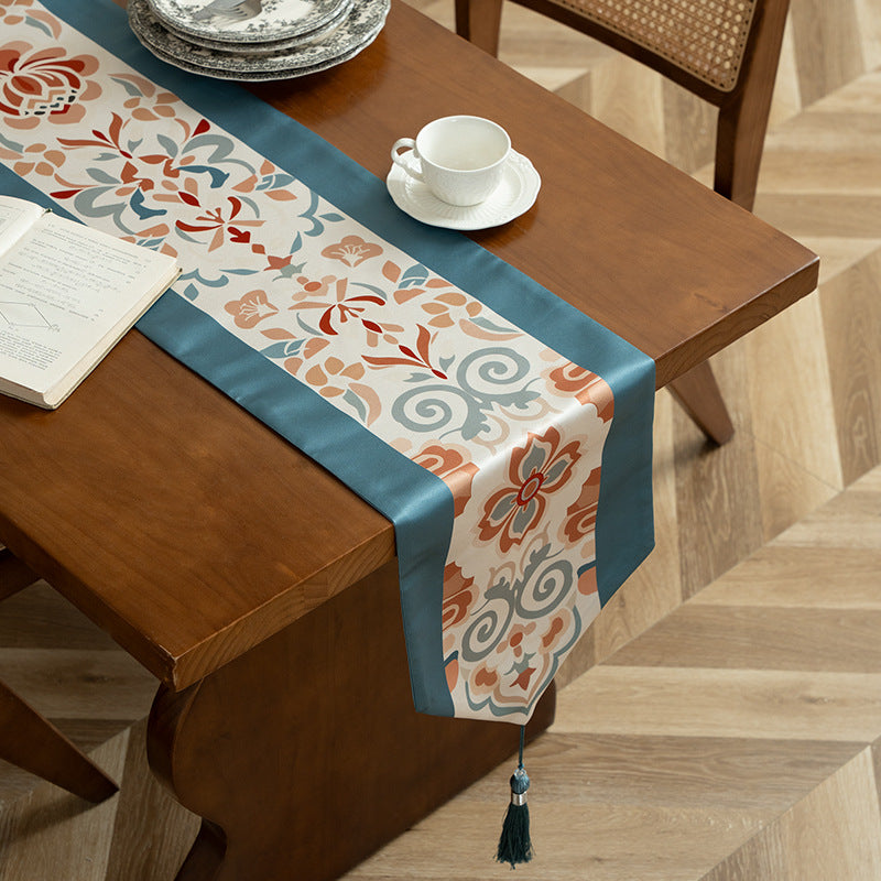 Handcrafted satin table runner with Oriental medallion pattern and decorative tassels