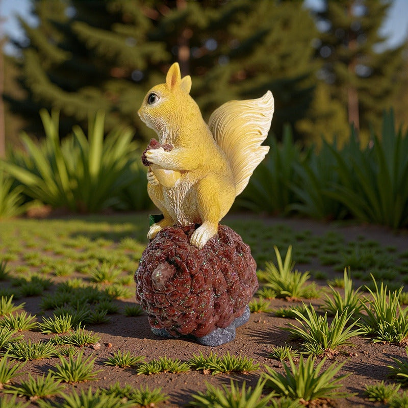 Decorative squirrel sculpture on a pine cone