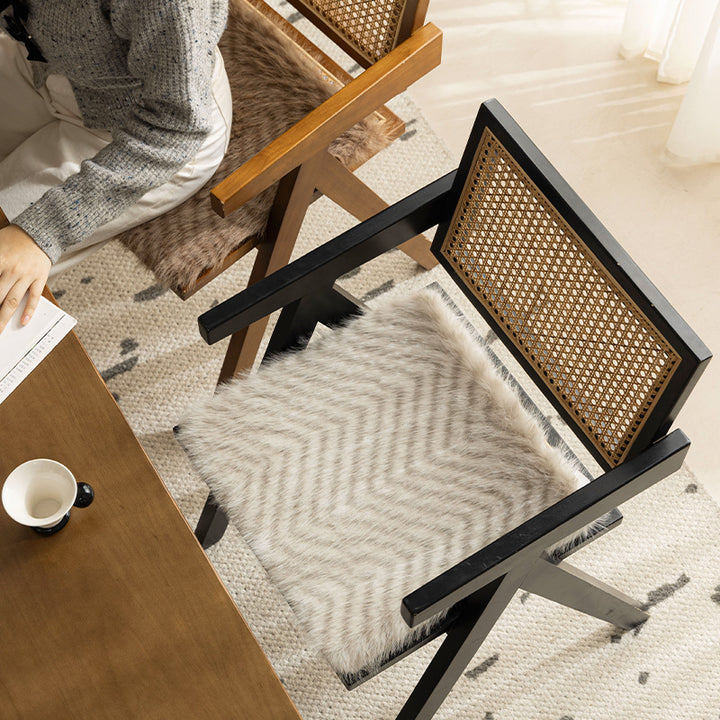 Square chair cushion made of cozy artificial fur with non-slip base and strap attachment