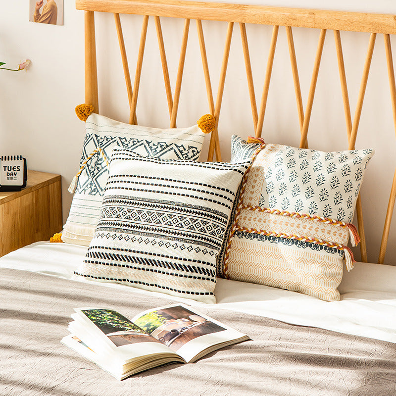 Woven decorative cushion cover in ethnic mix with braided ribbon and tassels