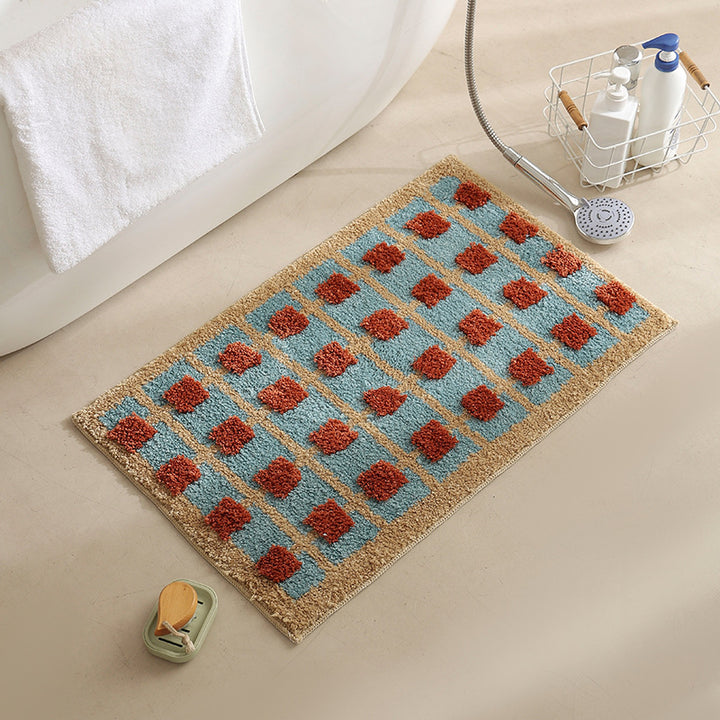 Hand-tufted bathroom bath mat with non-slip backing and textured square relief