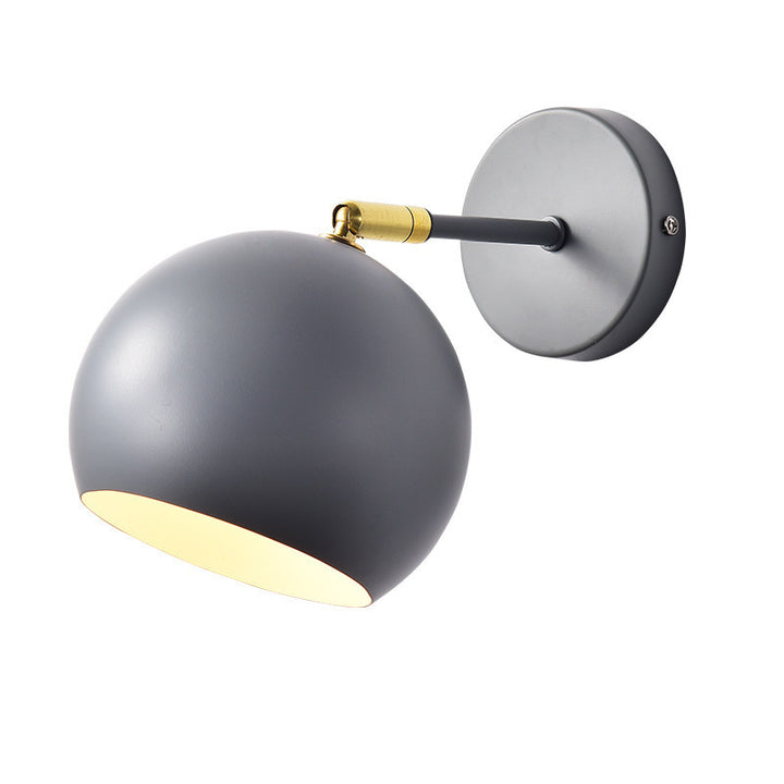 Adjustable matte metal globe wall lamp with brass pivot arm