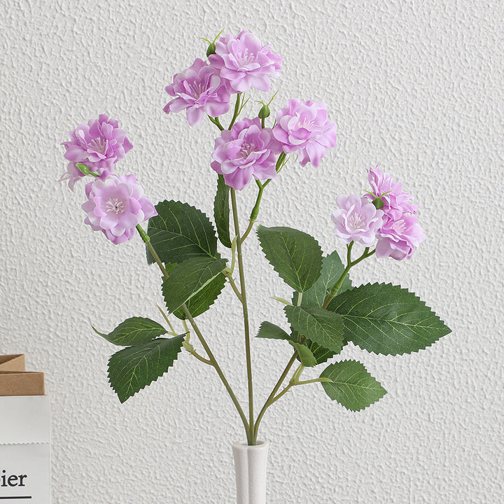 Artificial flower arrangement with delicate white blooms