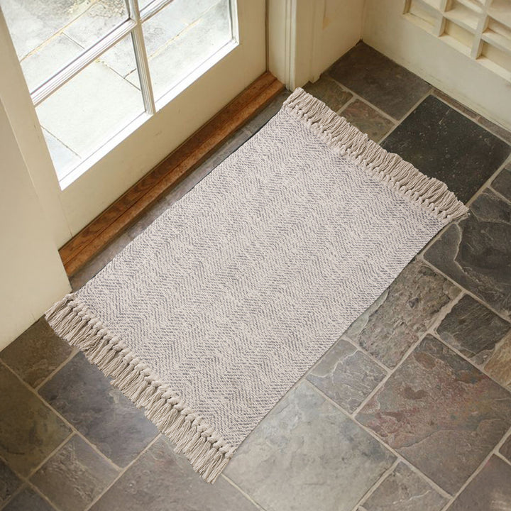 Handwoven runner rug with chevron weave and long fringes