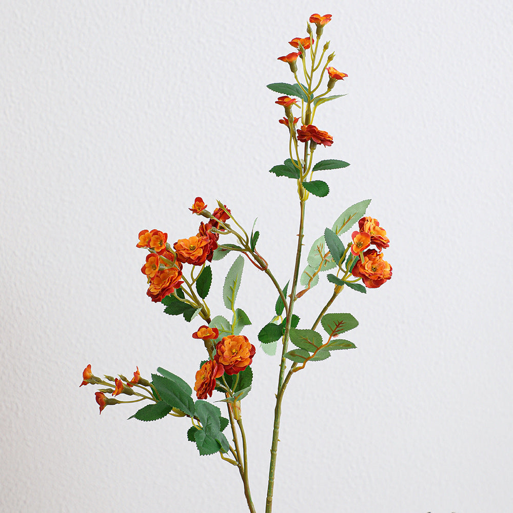 Artificial branch with decorative flowers