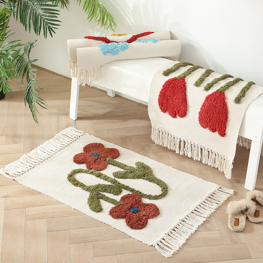 Handwoven cotton bath mat rug with tufted flower appliqué and tassels