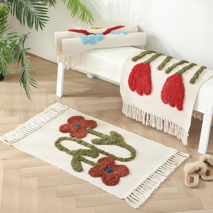 Handwoven cotton bath mat rug with tufted flower appliqué and tassels