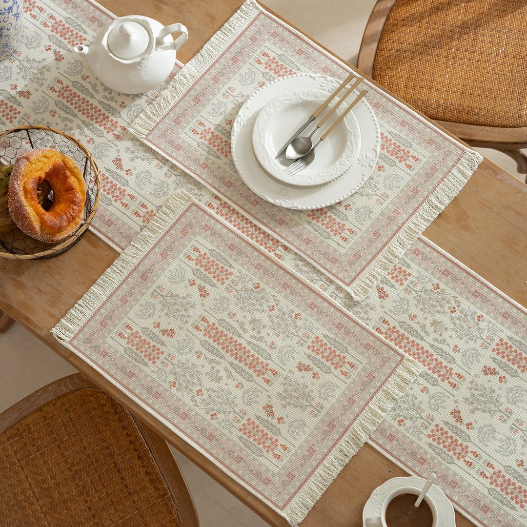 Vintage-inspired woven table runner with floral border and fringes