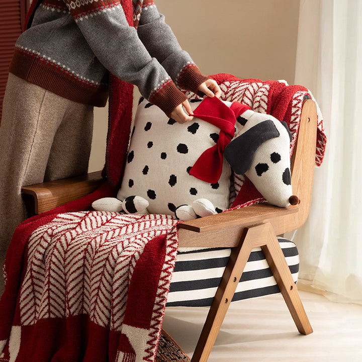 Decorative knitted cuddle pillow in the shape of a dog with a quilted body and bow detail