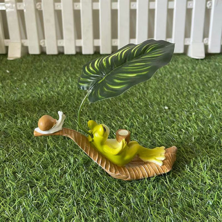 Funny frog figure with leaf decor