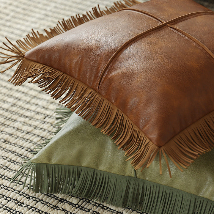 Decorative faux leather cushion with fringes and decorative seam