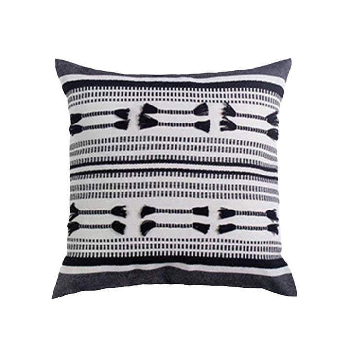 Woven decorative cushion cover with ordered tassel application and structured jacquard weaving
