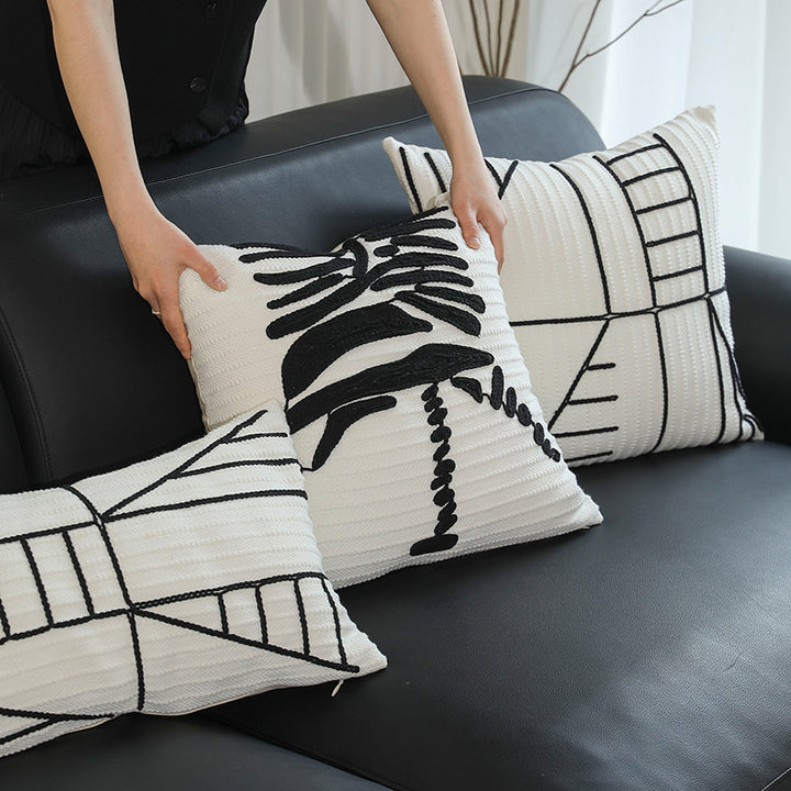 Decorative cushion cover with textured embroidery and geometric line motif