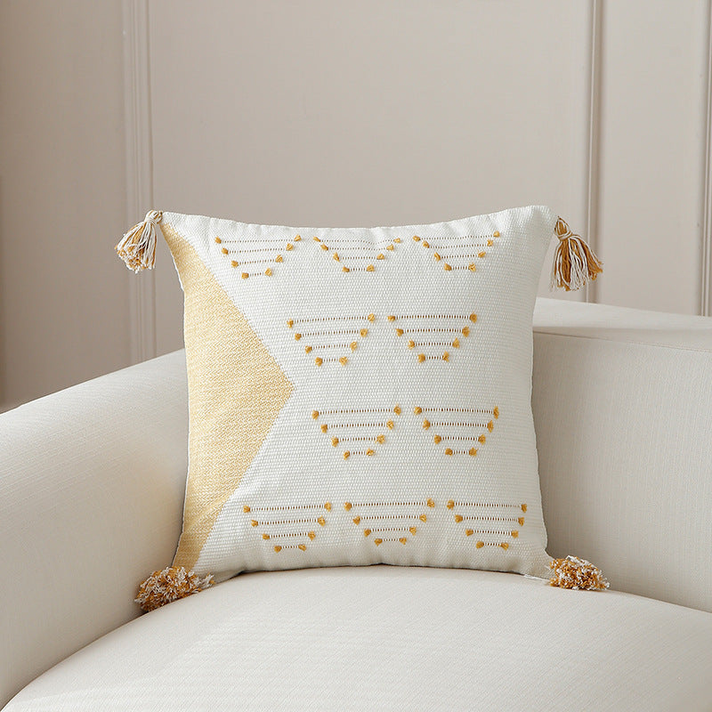 Decorative woven cushion cover with geometric tuft-relief and tassels