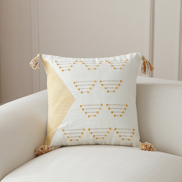Decorative woven cushion cover with geometric tuft-relief and tassels