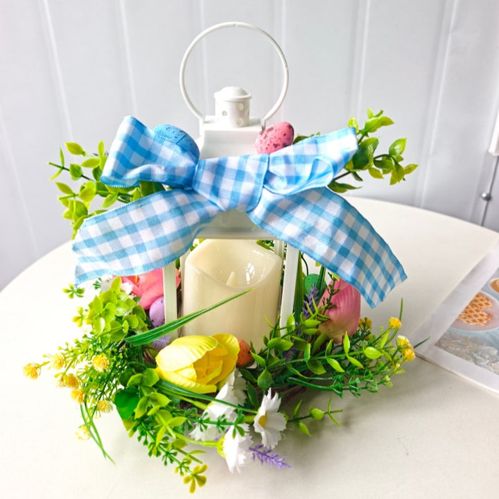 Decorative table lantern with artificial flowers and ribbon