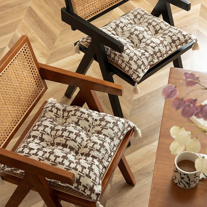 Decorative woven seat cushion with tufting and tassels