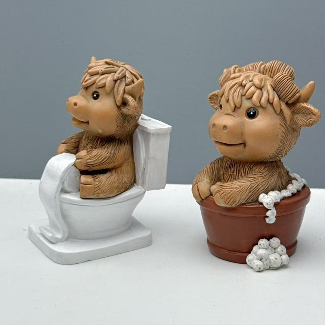 Funny decorative figure of a Highland cow on toilet