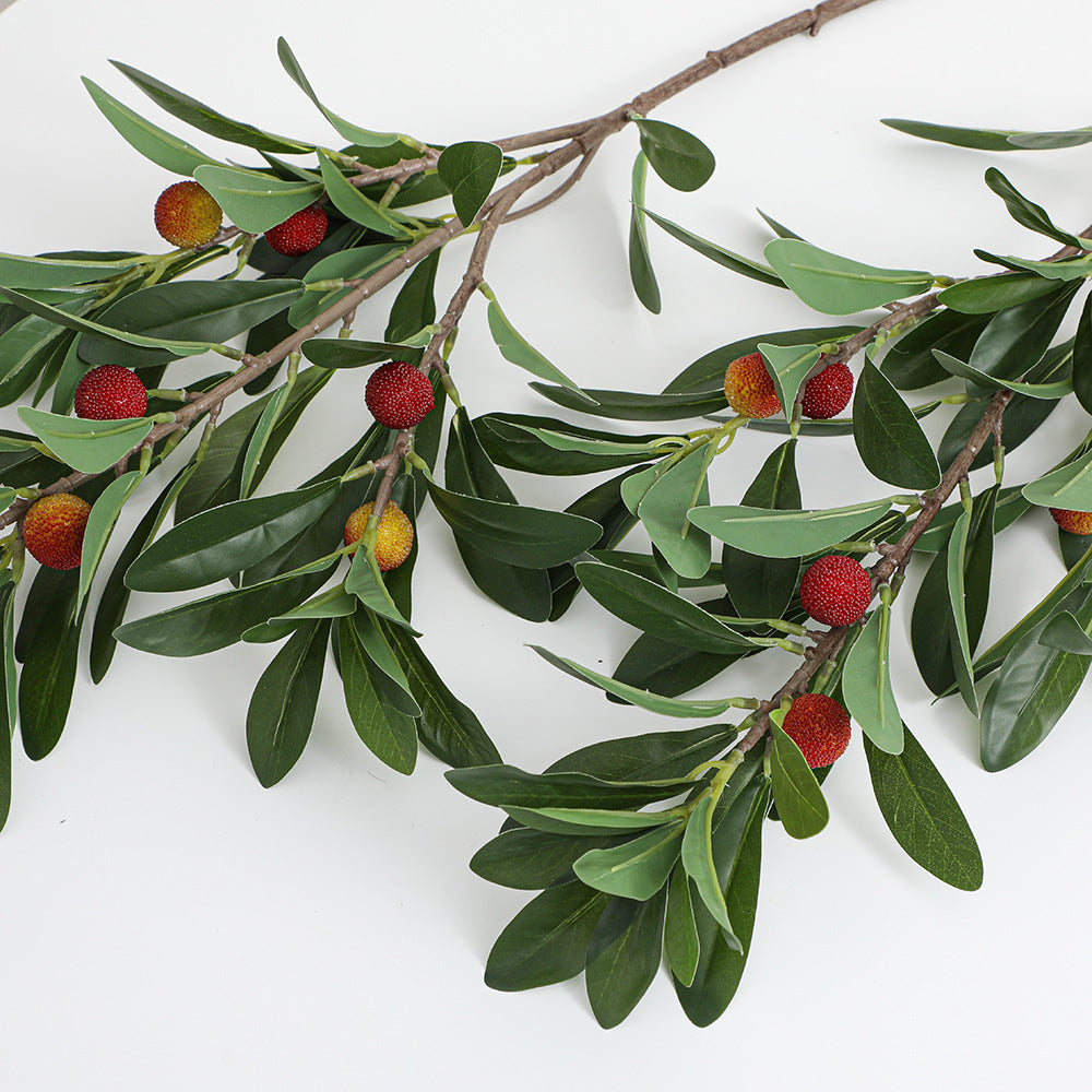 Artificial branch with decorative fruits
