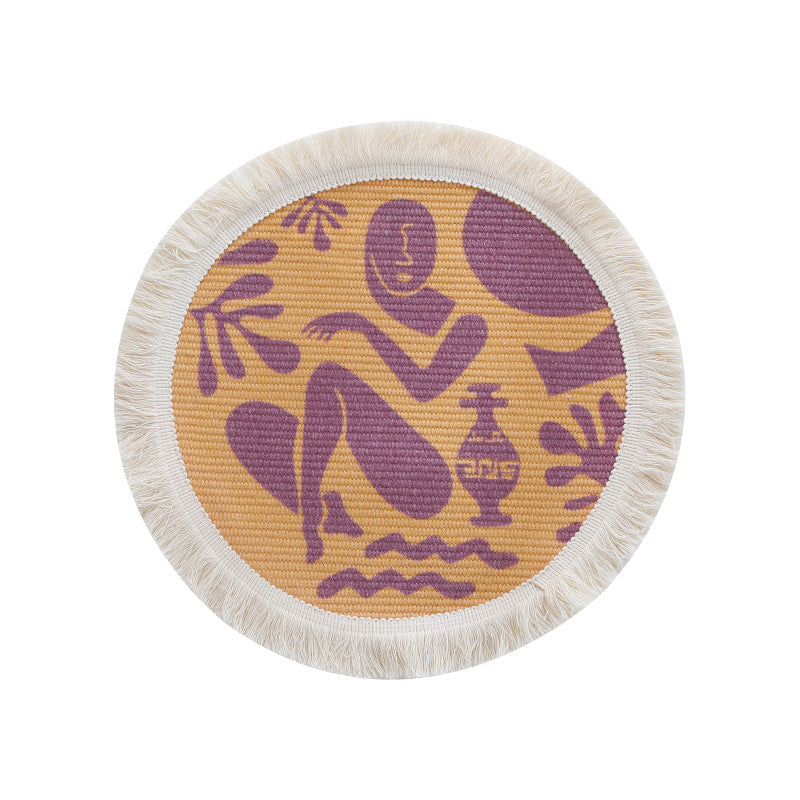 Round woven placemat with fringes and abstract figure motif
