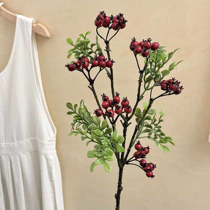 Artificial branch with glowing berries and green