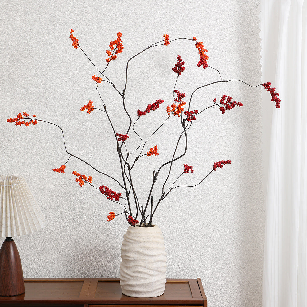 Decorative artificial flower branch with glowing red berries