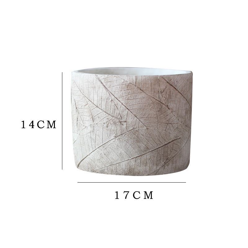 Decorative plant container made of handmade ceramic with leaf pattern