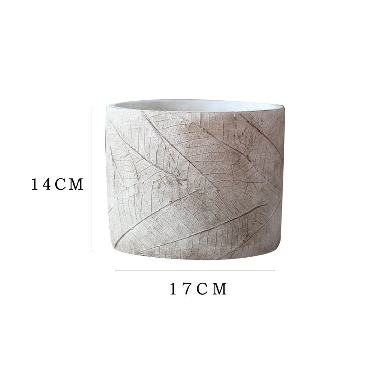 Decorative plant container made of handmade ceramic with leaf pattern