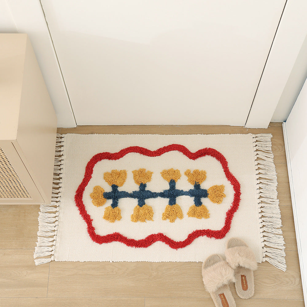 Handwoven cotton bath mat rug with tufted flower appliqué and tassels