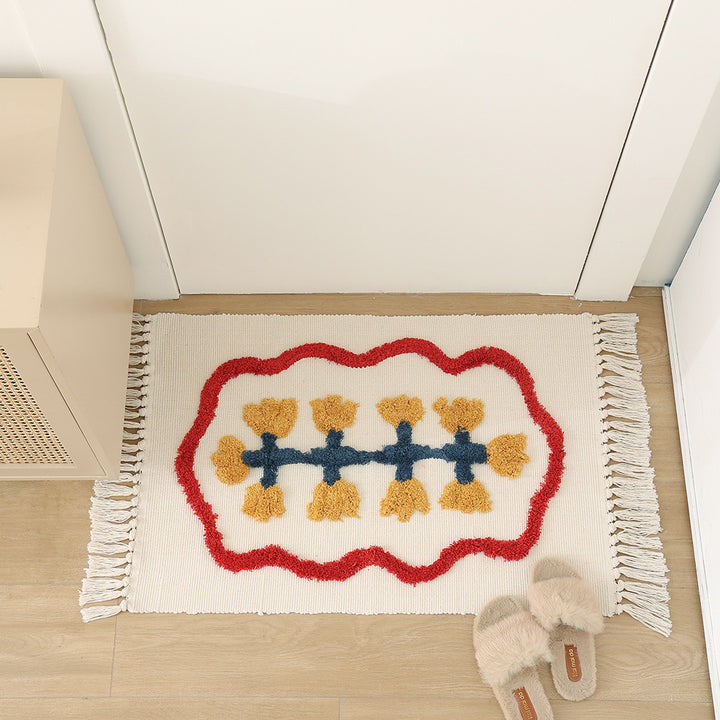Handwoven cotton bath mat rug with tufted flower appliqué and tassels
