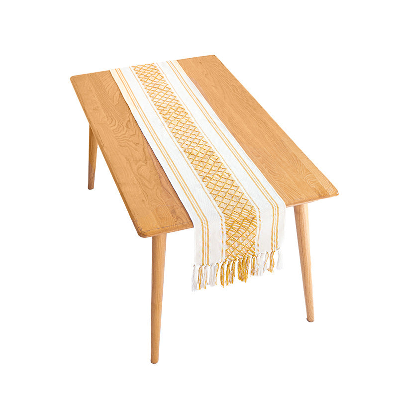 Handwoven cotton table runner with ethnic diamond pattern and fringes