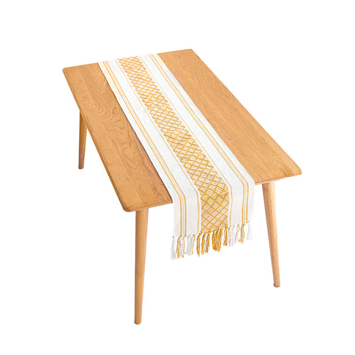 Handwoven cotton table runner with ethnic diamond pattern and fringes
