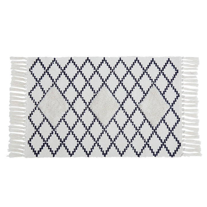 Flat Boho runner rug made of cotton blend fabric with geometric hexagon tufting and decorative fringed edge.