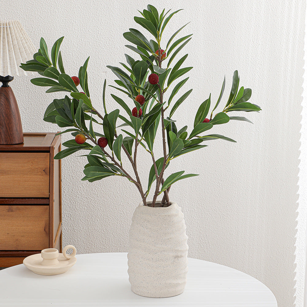 Artificial branch with decorative fruits