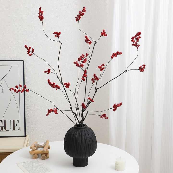 Decorative artificial flower branch with glowing red berries