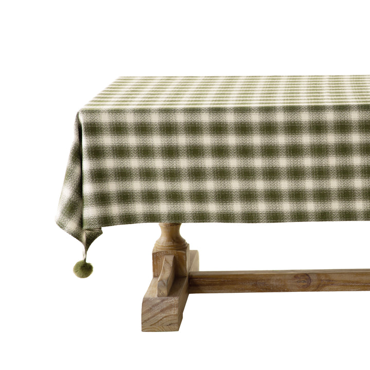 Square tablecloth made of cotton blend fabric with checkered weave pattern and pom-pom corners